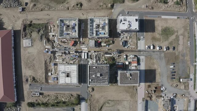 Aerial view of the construction site in Bessungen with several buildings under development, cranes, and materials in Darmstadt, Hessen, Germany.