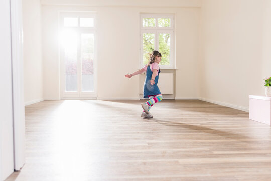 Happy girl running in empty apartment