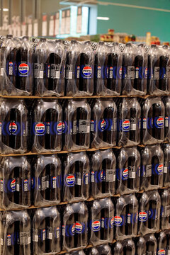 Varna. Bulgaria. 21.05.2026 tall stacked display of pepsi zero sugar one liter plastic bottles wrapped in clear plastic film at supermarket, green ceiling and store interior in background