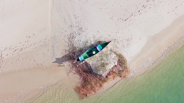 Top down aerial view of canoe resting on sandbank at Noosa River