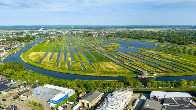 Aerial view of the Oosterdel nature reserve with its unique network of small islands and water channels under a clear sky in Broek op Langedijk, Noord-Holland, Netherlands.