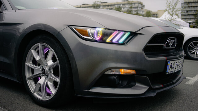 Kyiv, Ukraine - October 20, 2023. Close-up of a custom Ford Mustang with colorful headlight details displayed at Kyiv Car Fest, an automotive event featuring modified, sports and enthusiast vehicles.