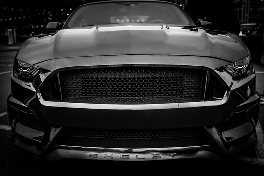 Kyiv, Ukraine - October 20, 2023. Front view of a black Ford Mustang displayed at Kyiv Car Fest, an automotive event featuring custom sports cars, modified vehicles, and collector automobiles.