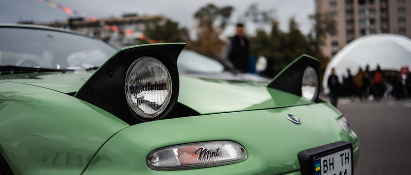 Kyiv, Ukraine - October 20, 2023. A green Mazda MX-5 Miata with a raised pop-up headlight was displayed at Kyiv Car Fest, an automotive event featuring classic, custom, and enthusiast cars.