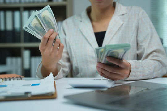 Business owner or accountant is processing financial transactions, managing cash flow, and handling monetary funds, symbolizing profit, wealth, and economy in a professional setting