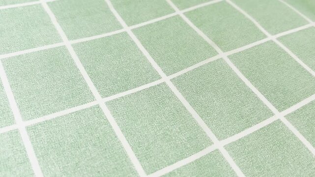 Light green checkered tablecloth with a white grid pattern slowly waving, perfect for a kitchen, picnic, or restaurant background with a rustic and traditional aesthetic