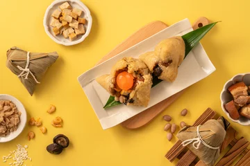 Traditional Chinese sticky rice dumpling Zongzi with side ingredients. © RomixImage
