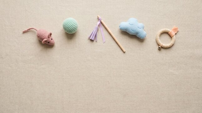 Set of cute baby toys on a beige fabric background