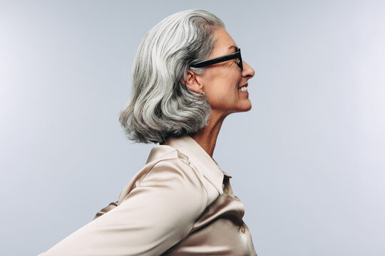 Woman smiling in profile during studio portrait