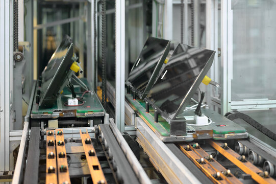 TV manufacturing plant conveyor system showcasing televisions being assembled for production