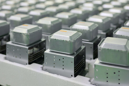 Magnetrons lined up in a manufacturing facility designed for microwave oven production and assembly processes