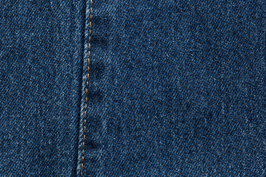 dark  blue jeans denim fabric texture background with seam