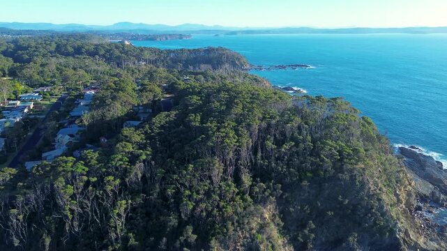 Drone aerial landscape of rural town housing among forest bushland in national park along coastline headland of Malua Bay and Lilli Pilli Beach on the South Coast NSW Australia nature and tourism