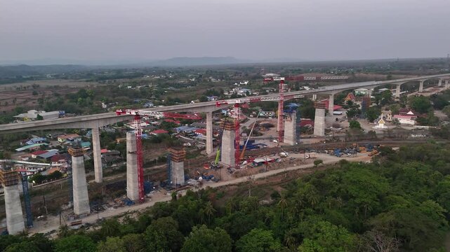 Aerial shot of transport megaproject connecting Thailand with Laos and China via railway, under construction.