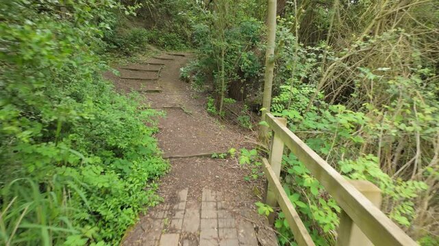 Crown Lakes Country Park, Peterborough, England, UK
Walking Point of View gimbal footage of walking over a boardwalk bridge and up some woodland steps and through a dense part of the woodland trail.