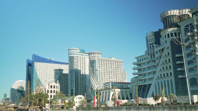 Timelapse view Batumi famous buildings, Georgia, Adjara region. Panning Orbi City view and Grand Gloria, fast flow of people on the embankment