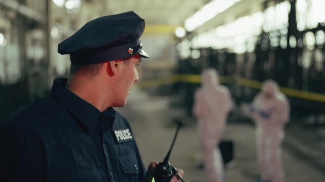 Police officer talking to superiors on radio at crime scene, discussing case
