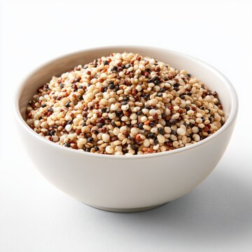 A white bowl filled with a colorful mix of uncooked tri-color quinoa grains on a white surface.