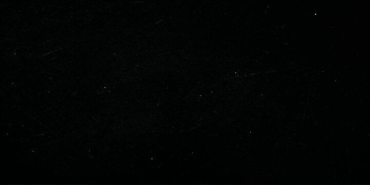 An abstract black and white grunge film texture background featuring dark space dust with bright lightning flashes and a magical night sky star effect for video alpha channel compositions