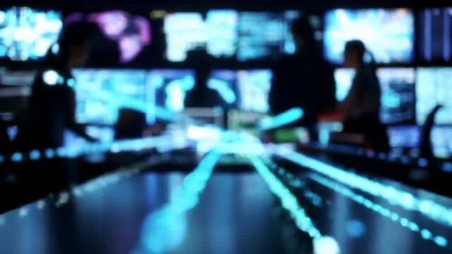 Sophisticated futuristic control room at night with cool digital data visualizations, blurred human silhouettes, a hand gesturing. Concept of digital transformation and AI
