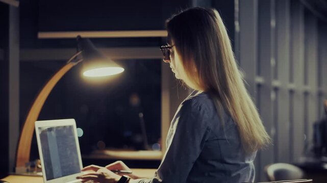 Programmer Typing On Laptop Computer Keyboard Working Late At Night. Developer Coding Software Script In Dark Office