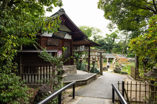 Traditional Japanese garden with wooden house surrounded by trees in serene imperial setting, Kyoto, Japan 