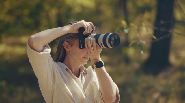 Photographer Taking Photos With Professional Camera. Freelancer Holding Telephoto Lens Device In Forest