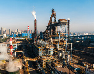 Fototapeta premium Aerial view of Wuhan steel plant, featuring a complex geometry of massive blast furnaces and intricate pipelines. It reflects China's industry and economy evolution, producing silicon steel for electr