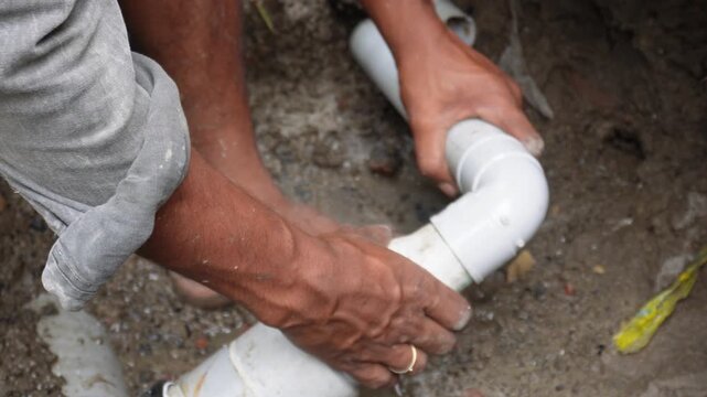 Plumber Repairing Plastic Pipes with Precision and Focus