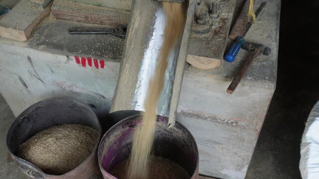 Traditional rice milling process in rural farming village
