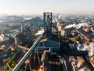 Naklejka premium Aerial view of Wuhan steel plant, featuring a complex geometry of massive blast furnaces and intricate pipelines. It reflects China's industry and economy evolution, producing silicon steel for electr