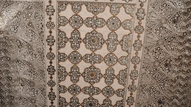 Majestic view revealing the intricate mirror work, known as Sheesh Mahal or Palace of Mirrors, on the ceiling of the Amer Fort, a stunning example of Mughal architecture in Rajasthan