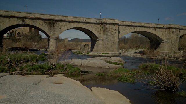 Historic stone arch bridge over the Tormes river in Puente del Congosto