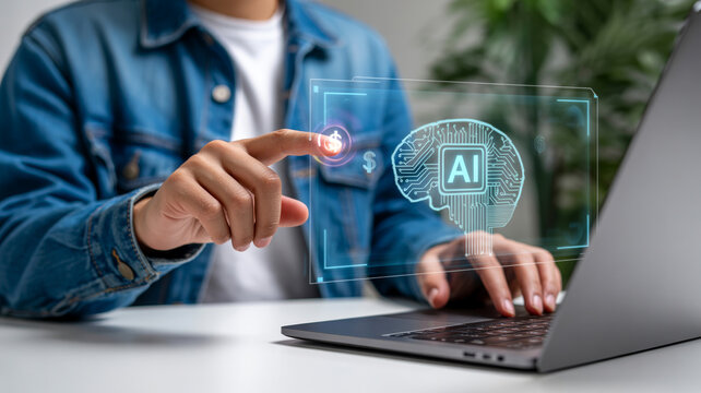 A person pointing at a digital projection of an artificial intelligence brain circuit board on a laptop, signifying AI technology.