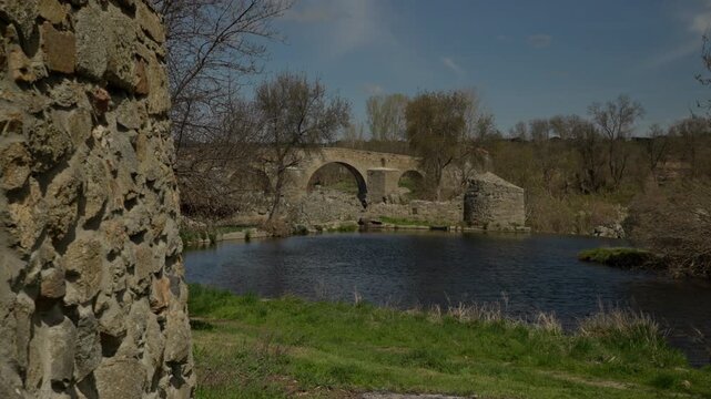 Puente del Congosto ancient stone bridge and calm connecting river creating a...