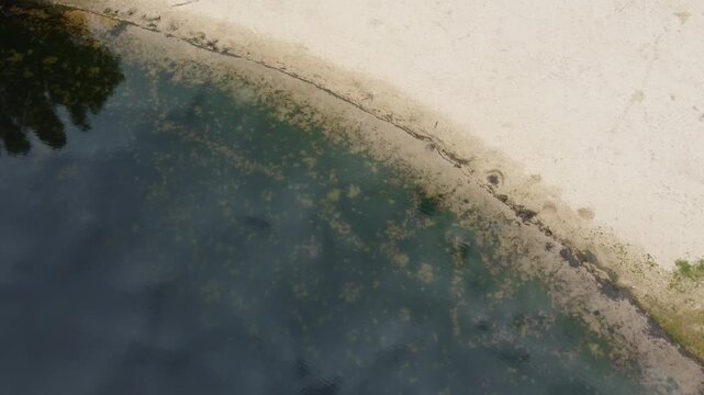 Aerial view of a lake and sand