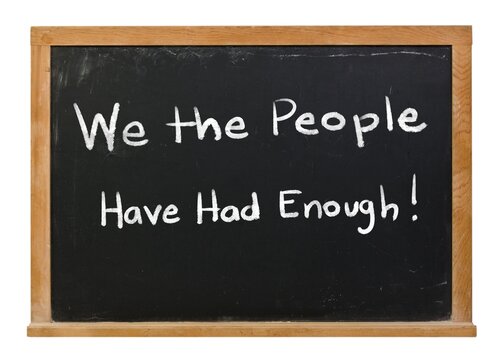We the People have had enough written in white chalk on a black chalkboard isolated in a wooden frame on white