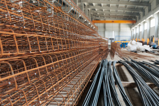 Steel rebar cages forming building reinforcement in workshop