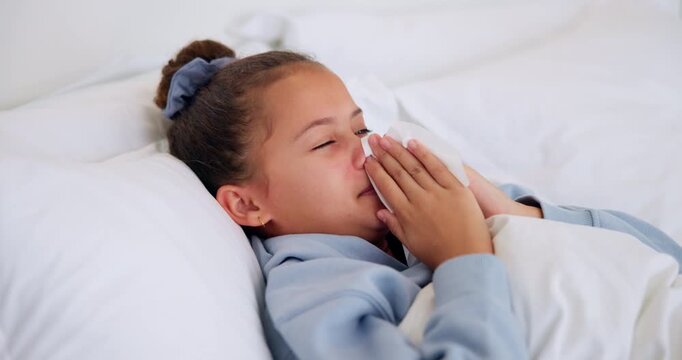 Sick, girl and blowing nose with tissue in bed for fever, influenza or viral infection in home. Child, kid and cough with cold, flu or sinus in bedroom sheets for hayfever, allergy or virus in house