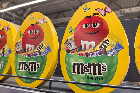 Colorful candy display featuring M and M's and friends in a bright store