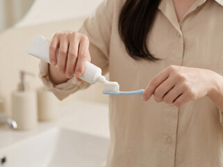 Obraz premium 칫솔에 치약을 짜는 모습 / Squeezing Toothpaste onto Brush