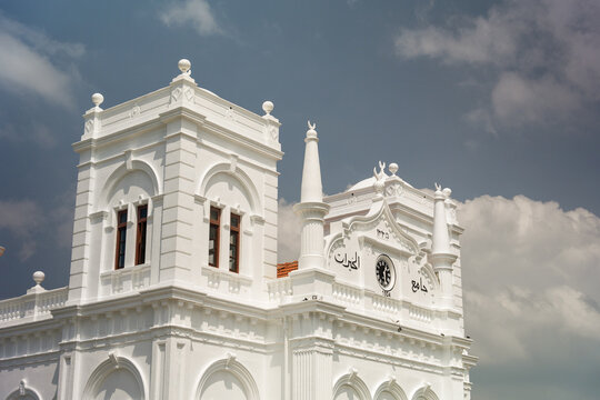 View of the historic white facade and clock tower of the Meeran Jumma Mosque under a cloudy sky in Galle, Southern Province, Sri Lanka.