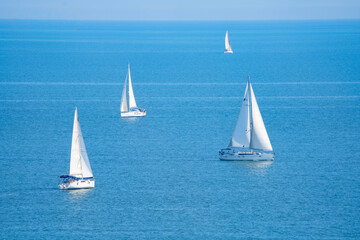 Fototapeta premium White sailboats on the blue sea 