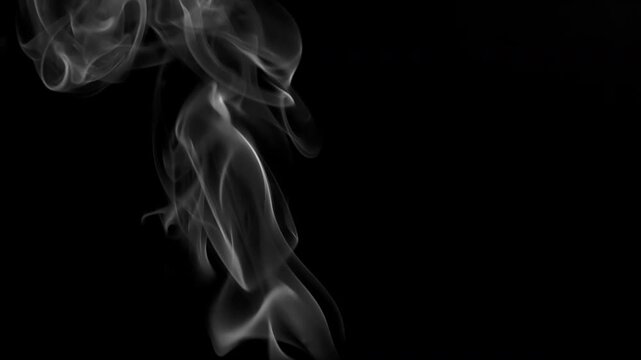 Slow Cigar Smoke Twirls. Slow White smoke rises lazily on a black background