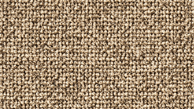 Full frame macro of beige berber loop carpet with tightly packed knotted yarn pile