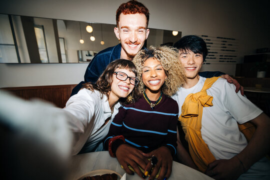 Happy diverse friends group taking a selfie together