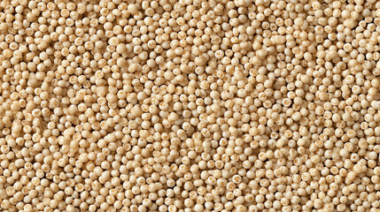 Fototapeta premium Warm golden cream Israeli pearl couscous grains piled densely to fill the frame