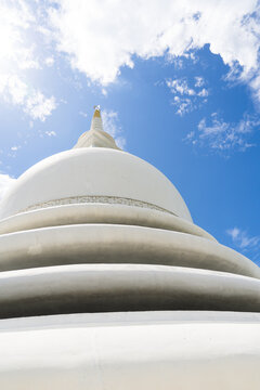 View of the Japanese Peace Pagoda - Rumassala showing the white stupa dome against a bright blue sky in Unawatuna, Southern Province, Sri Lanka.