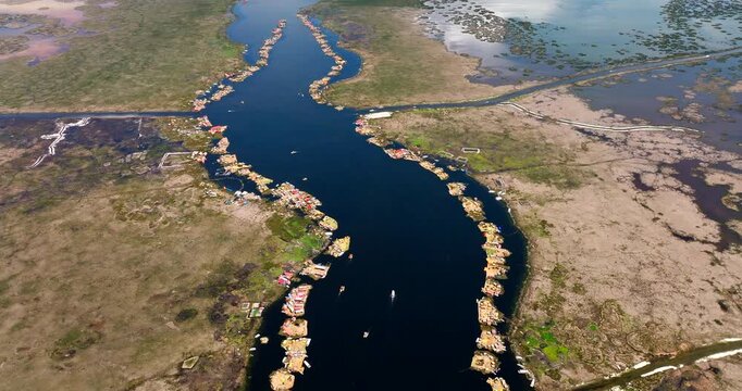 Man-made totora reed islands on Lake Titicaca near Puno, Peru. Aerial top-down forward
