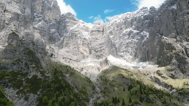 Aerial drone footage over Rifugio Settimo Alpini, Italy: dramatic Dolomite peaks, alpine landscape and remote mountain scenery under clear light. Ideal for nature and travel projects.